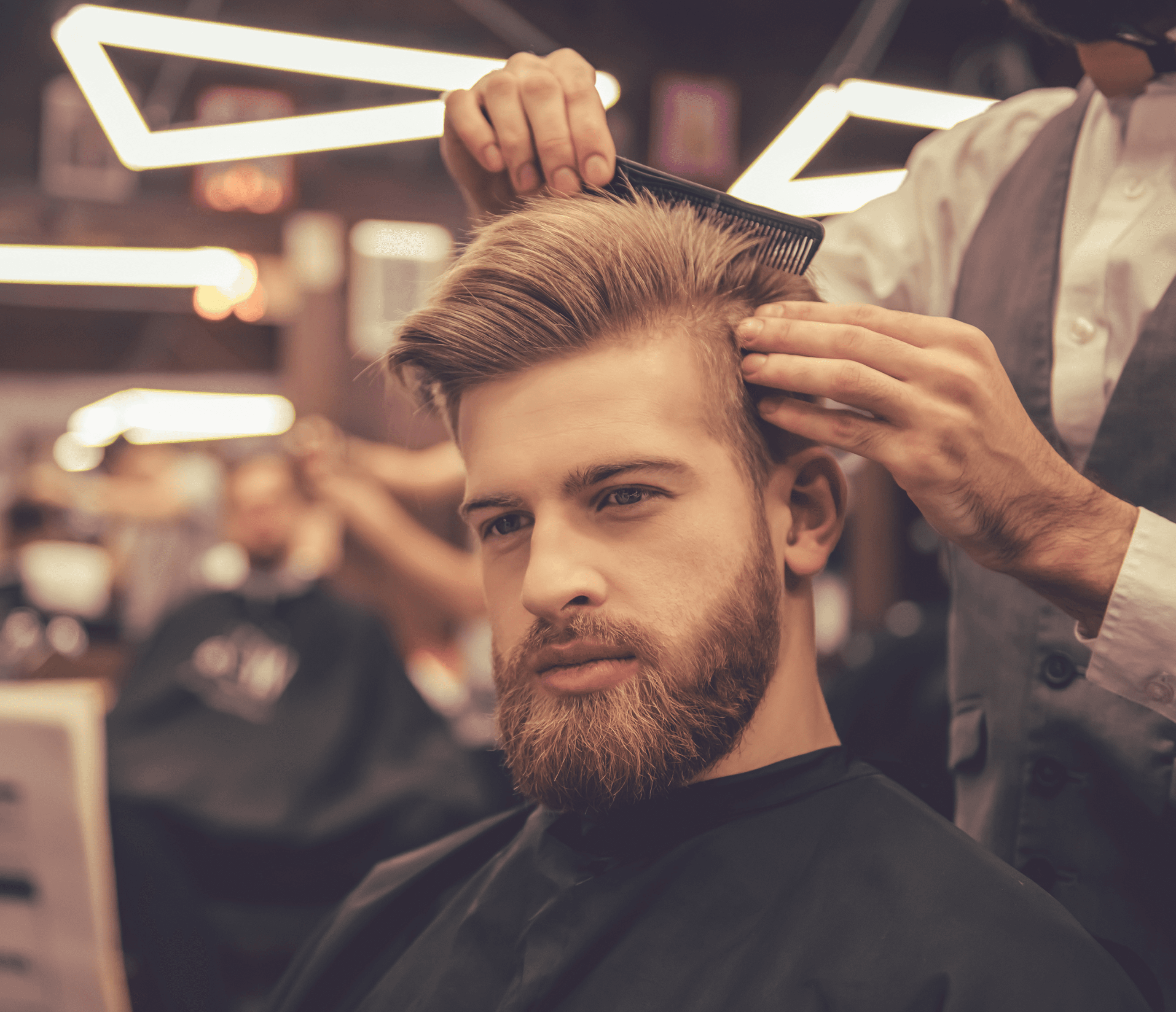 Customer getting a haircut at a local barbershop